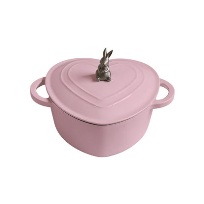 Pink heart-shaped pot with a rabbit on top on a white background