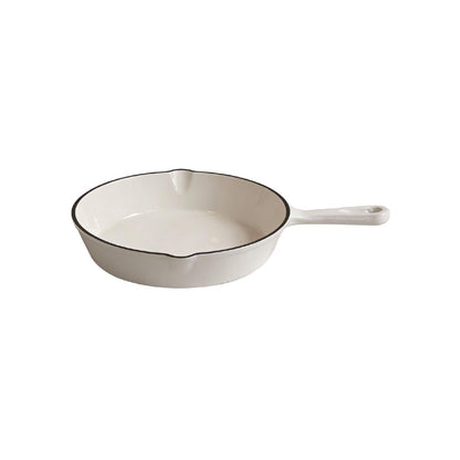 A white enameled cast iron skillet with a black rim and a white handle, shown on a plain white background.