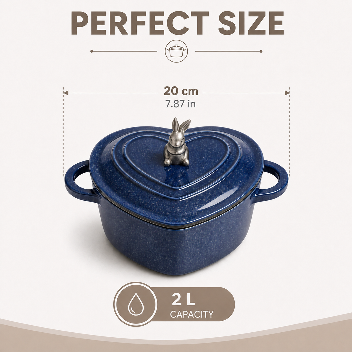 A dark blue heart-shaped cast iron pot with a lid and a rabbit-shaped knob, shown with dimension lines indicating a 20 cm (7.87 in) width and a 2 L capacity label on a light beige background.