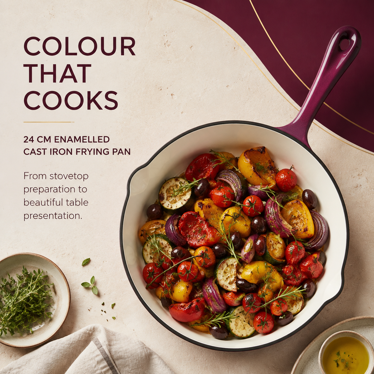 A 24 cm enamel cast iron frying pan with a deep purple handle, filled with roasted colorful vegetables, set on a beige textured surface with promotional text reading 'COLOUR THAT COOKS'.